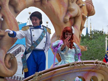 Little Mermaid and Prince Eric wave to parade onlookers